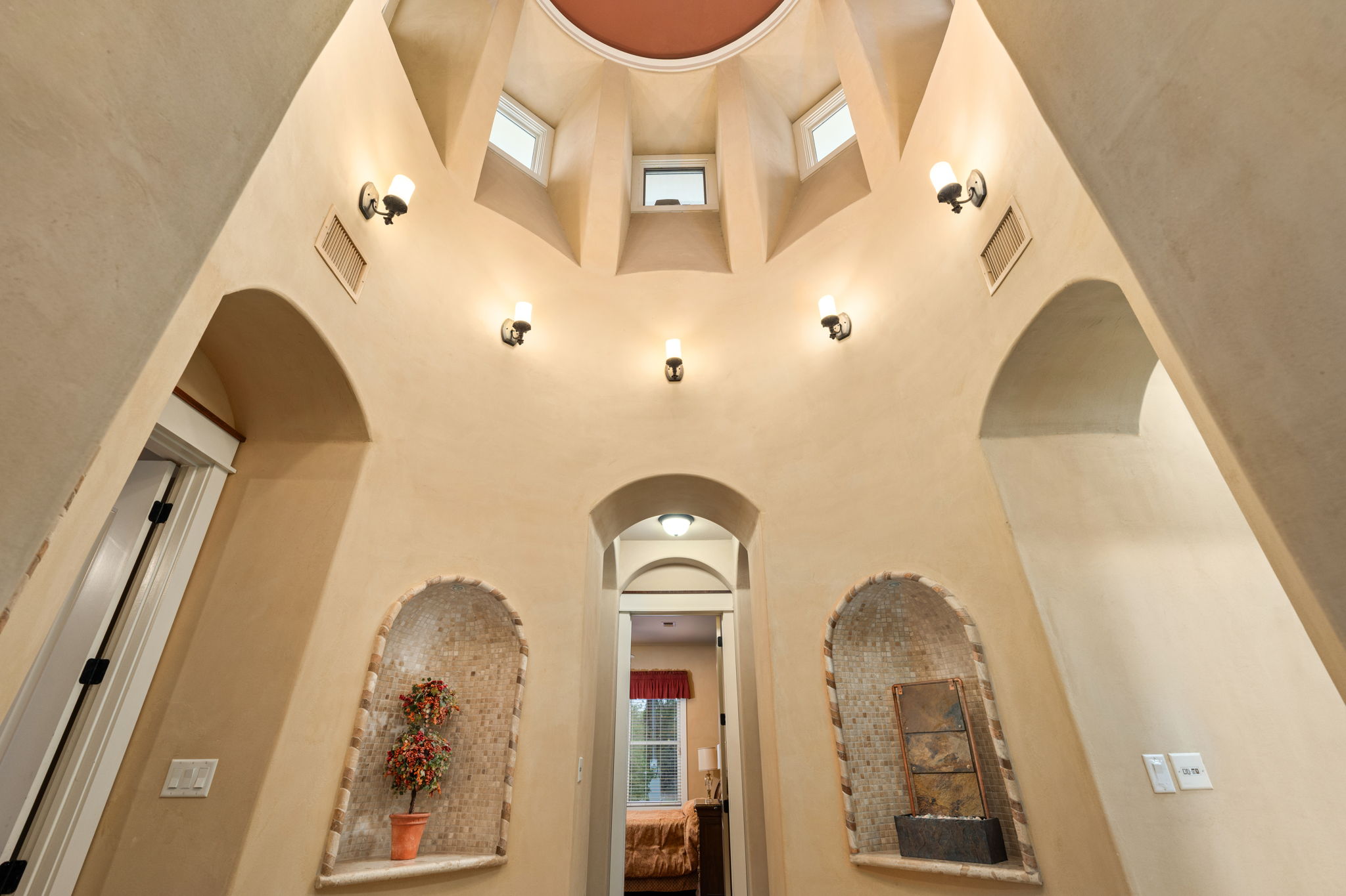 23426 Oscar Road Spicewood, TX 78669 - Photo 7 of 40 The home features an incredible Rotunda that you have to see in person to truly appreciate! This area leads to each of the bedroom. There are several built in lite niches and hidden rope light that enhances evening warmth.