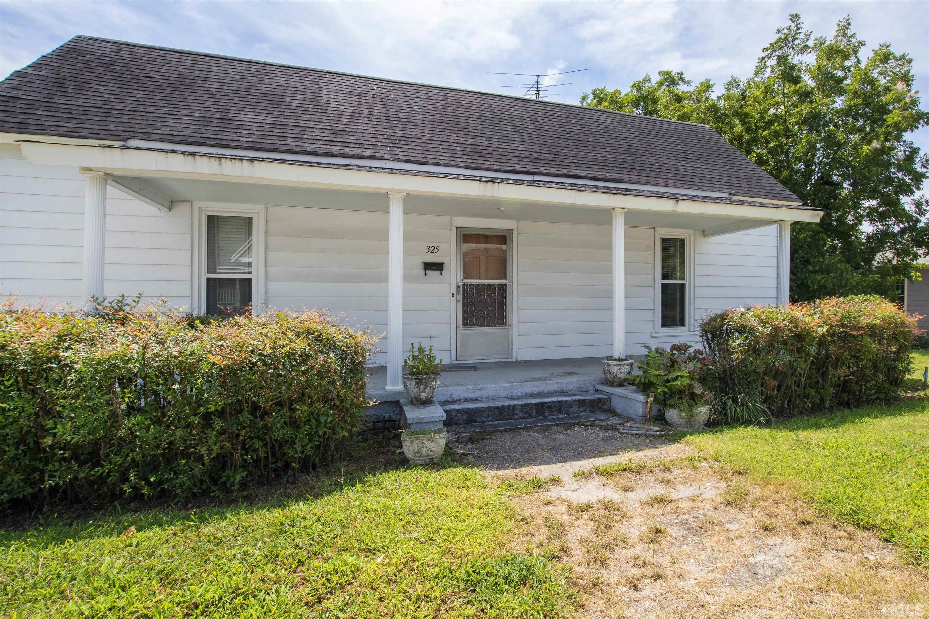 325 Maywood Avenue Raleigh, NC 27603 - Photo 1 of 30 a front view of a house with garden