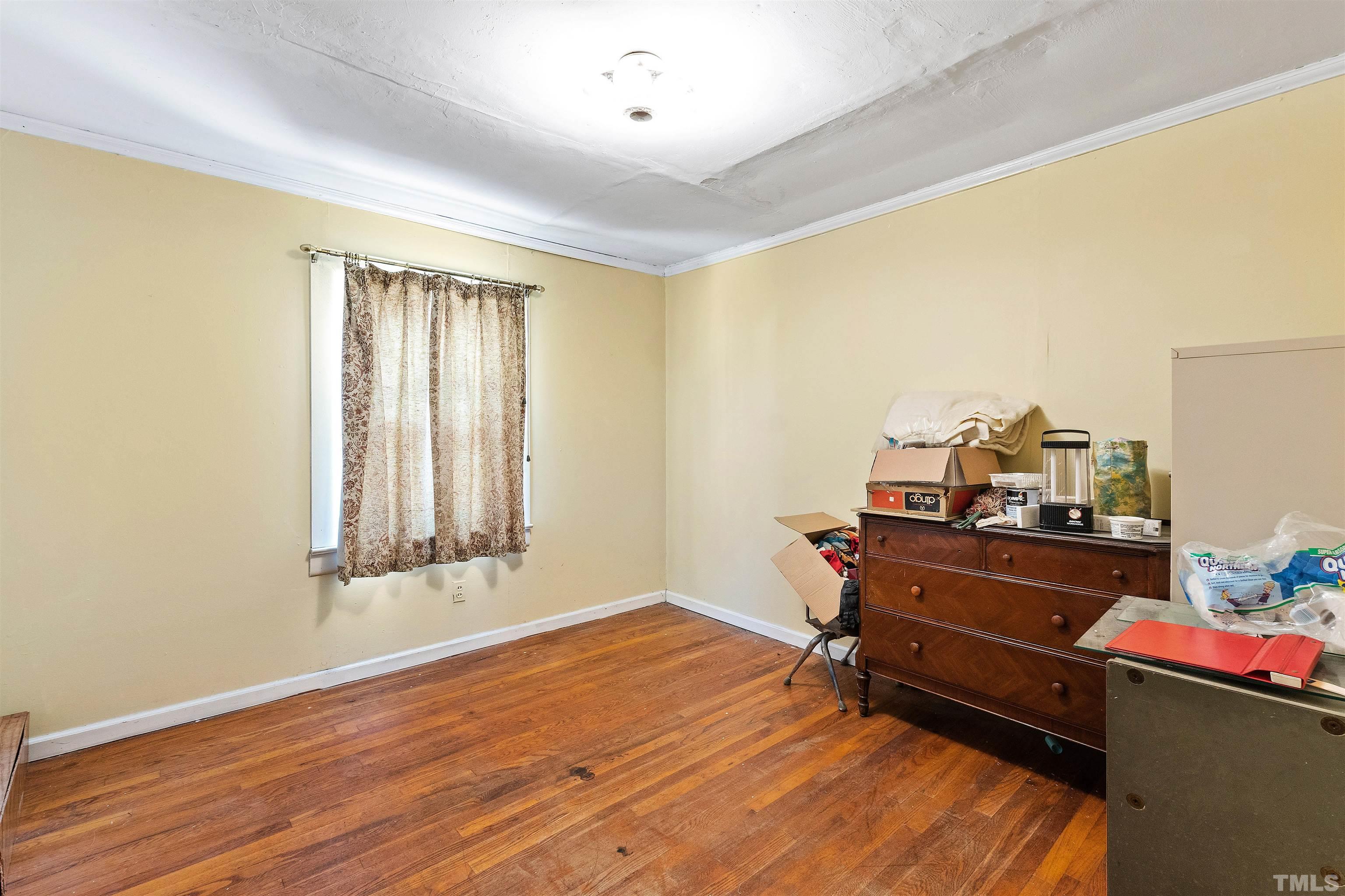 325 Maywood Avenue Raleigh, NC 27603 - Photo 10 of 30 a room with a wooden floor and furniture