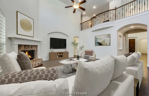a living room with fireplace furniture and a flat screen tv