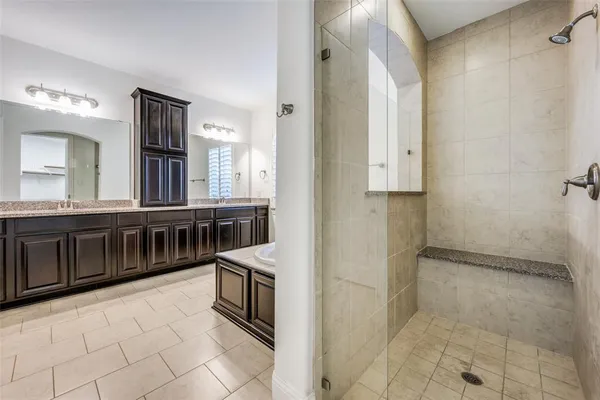 a bathroom with a sink a mirror and a shower