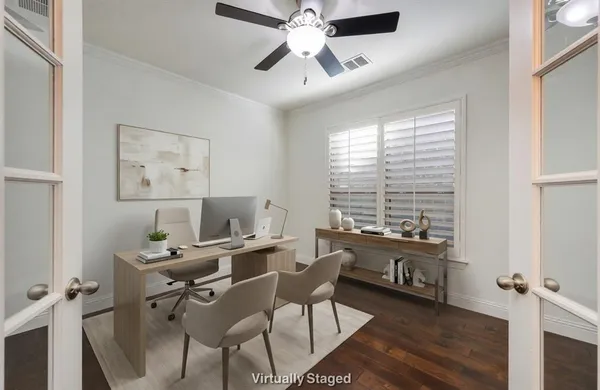 a view of a workspace with furniture and a window