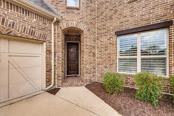 a front view of a building with potted plants