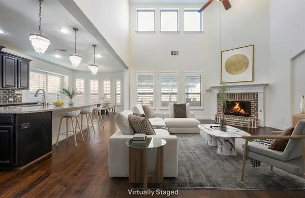 a living room with furniture a fireplace and a flat screen tv