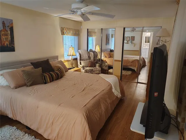 a bed room with a bed window and a mirror