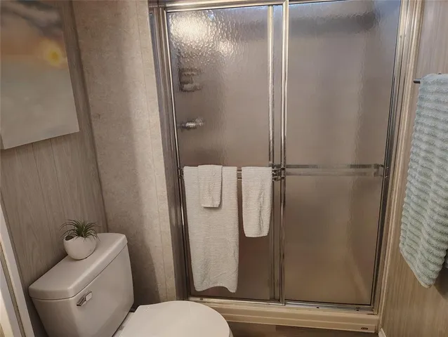 a bathroom with a shower and toilet