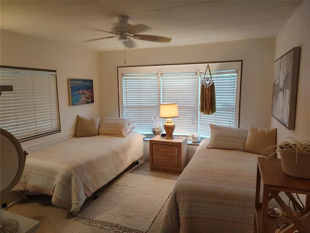 a bedroom with a bed a couch and a chandelier