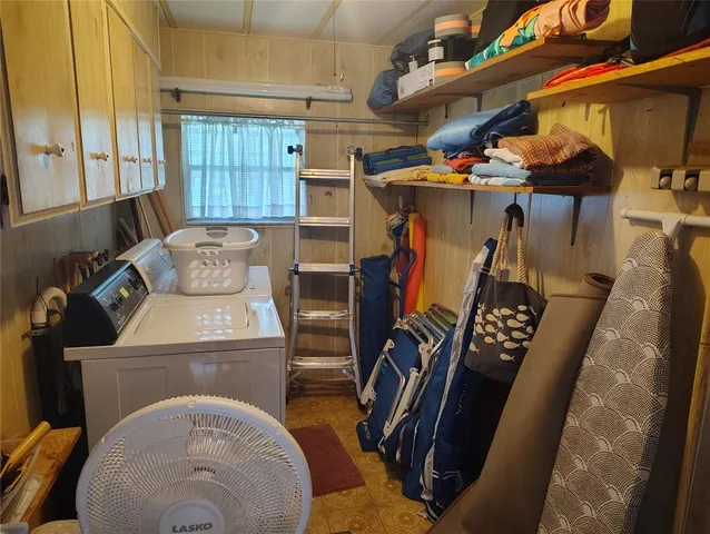 a utility room with furniture a washer and dryer