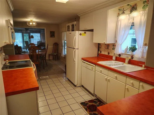 a kitchen with stainless steel appliances a refrigerator sink and cabinets