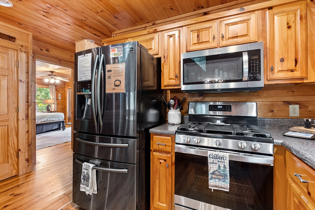 35 Wunder Bear Ridge Morganton, GA 30560 - Photo 18 of 76 a kitchen with stainless steel appliances granite countertop a stove a microwave and a refrigerator