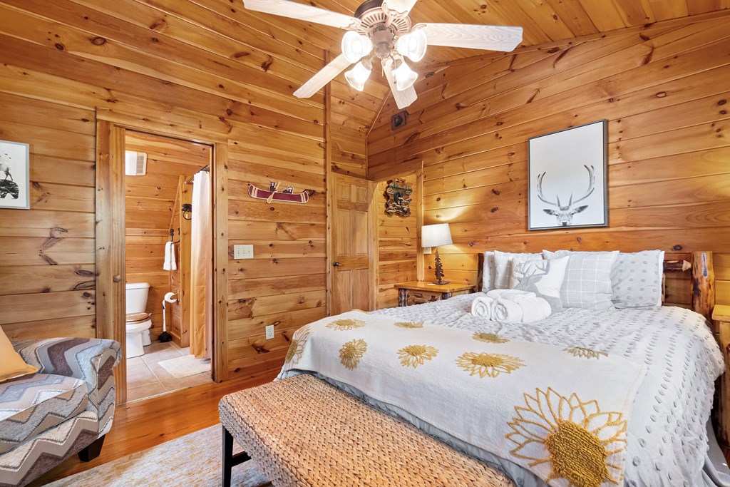 35 Wunder Bear Ridge Morganton, GA 30560 - Photo 28 of 76 a bedroom with a bed and a chandelier