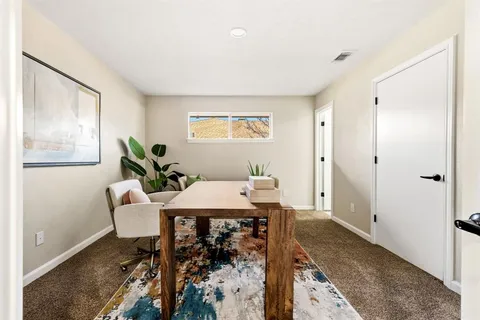 a view of a livingroom with furniture and window