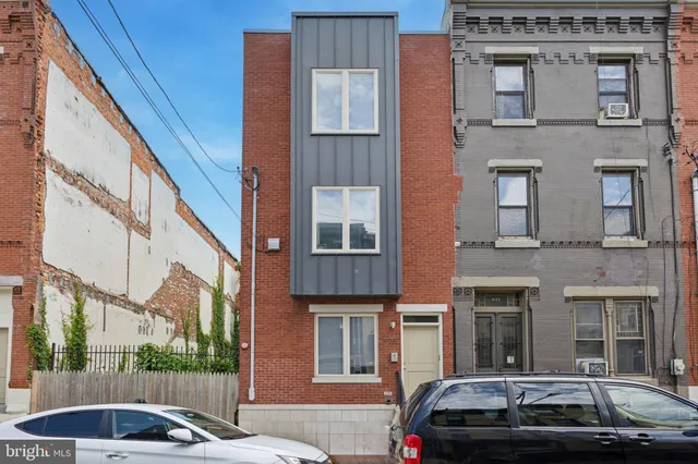 a view of a car parked in front of a building