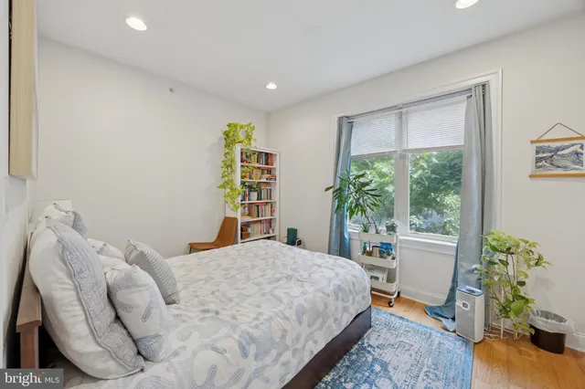 a bedroom with a bed and a window