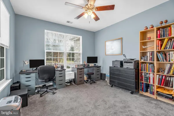 a view of a livingroom with workspace and a window