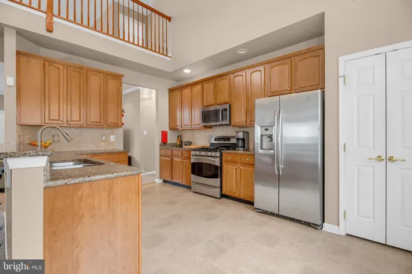 a kitchen with a refrigerator sink and cabinets