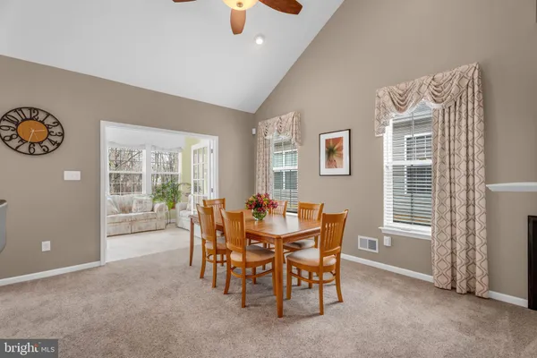 a view of a dining room with furniture and chandelier