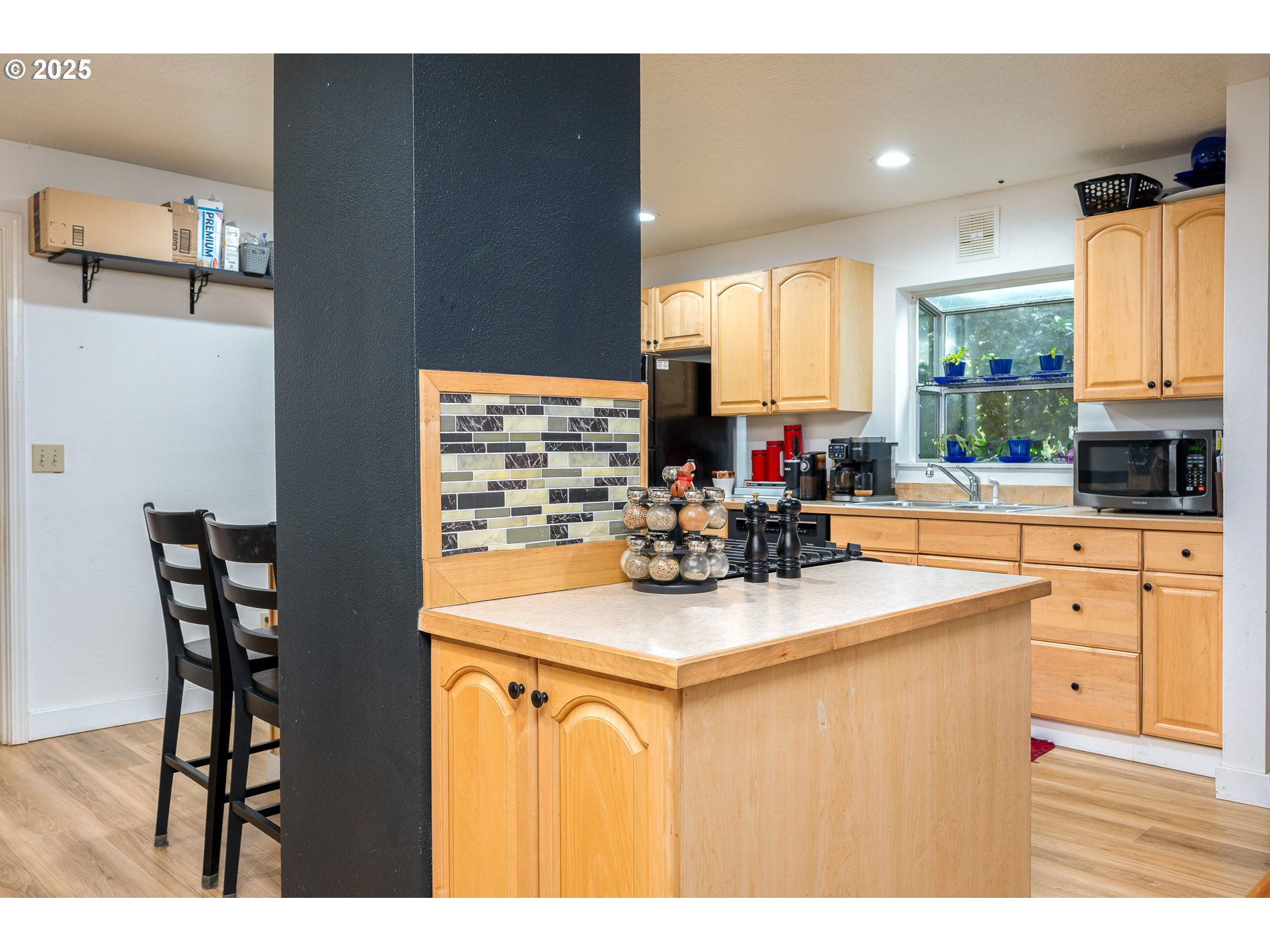 2837 Southeast 90th Place Portland, OR 97266 - Photo 11 of 40 a kitchen with kitchen island granite countertop a sink cabinets and window