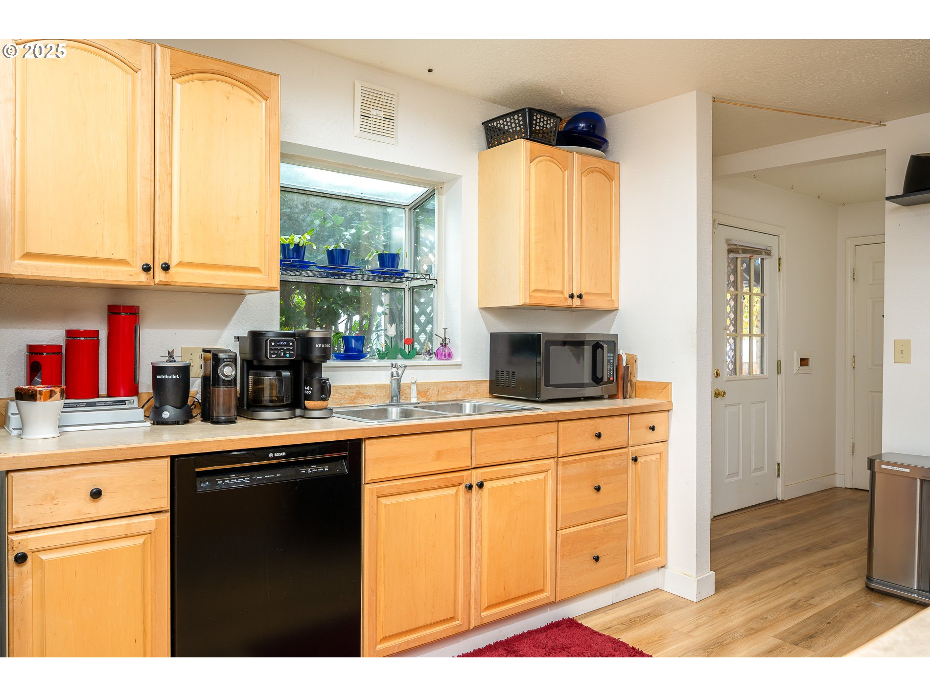 2837 Southeast 90th Place Portland, OR 97266 - Photo 13 of 40 a kitchen with stainless steel appliances granite countertop a stove a sink and a microwave