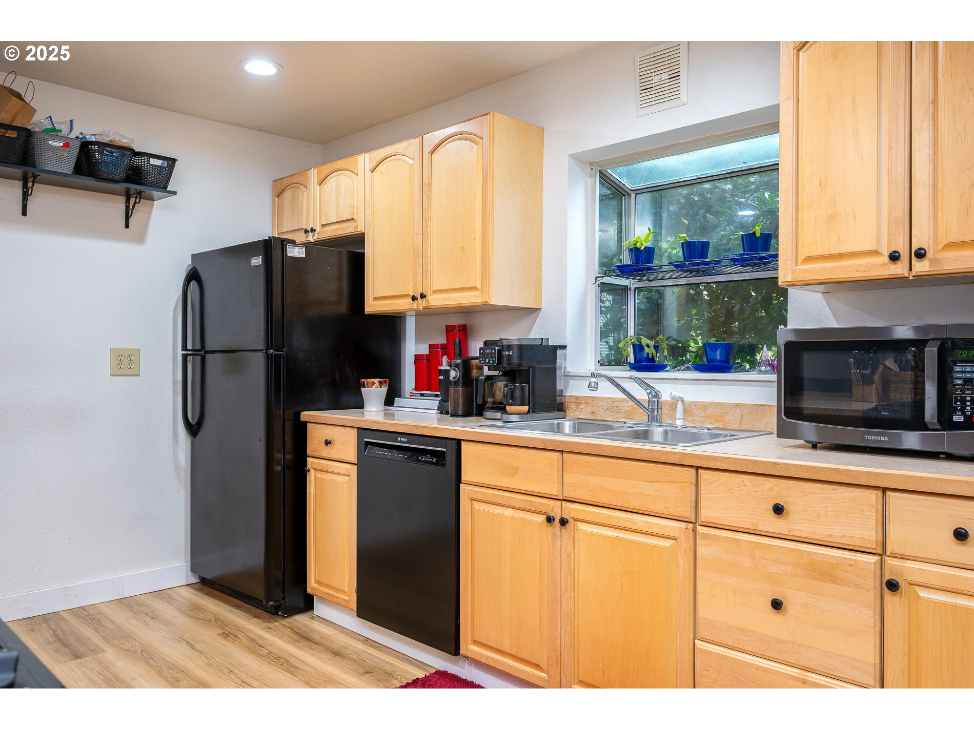 2837 Southeast 90th Place Portland, OR 97266 - Photo 14 of 40 a kitchen with a refrigerator and a sink