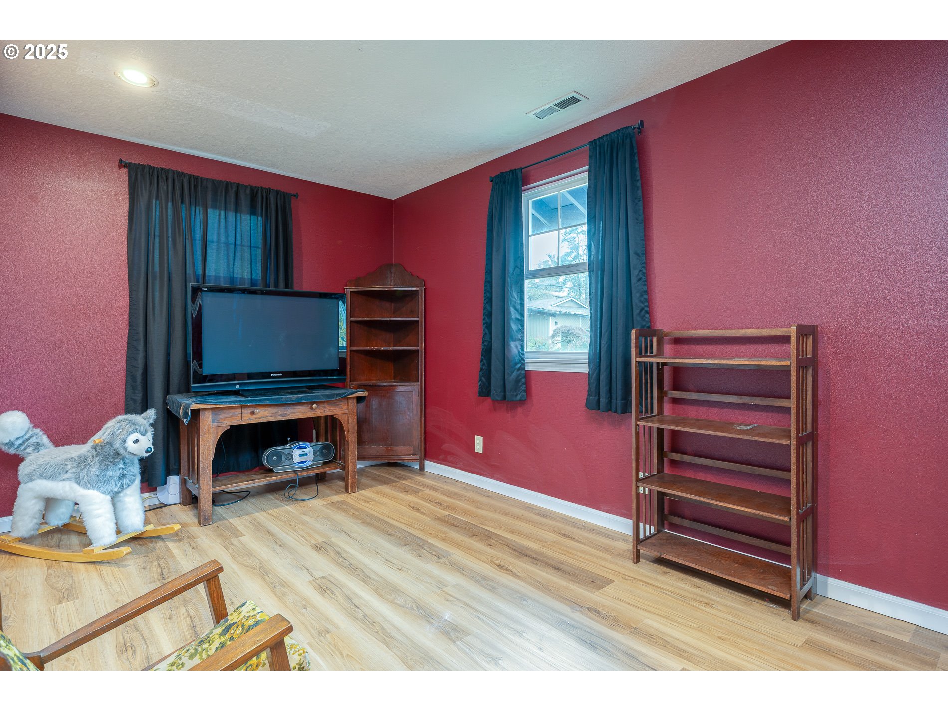 2837 Southeast 90th Place Portland, OR 97266 - Photo 26 of 40 a living room with furniture a flat screen tv and a fireplace