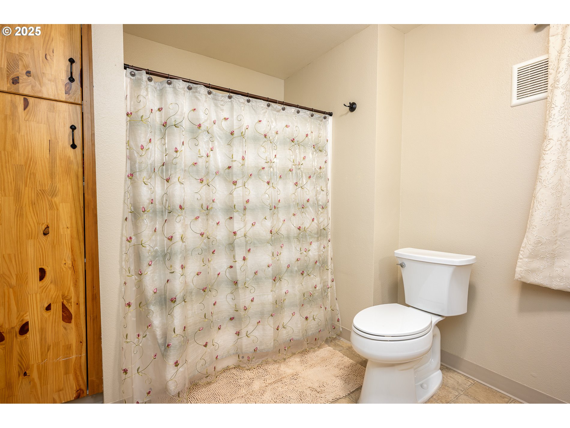 2837 Southeast 90th Place Portland, OR 97266 - Photo 29 of 40 a white toilet sitting next to a shower curtain