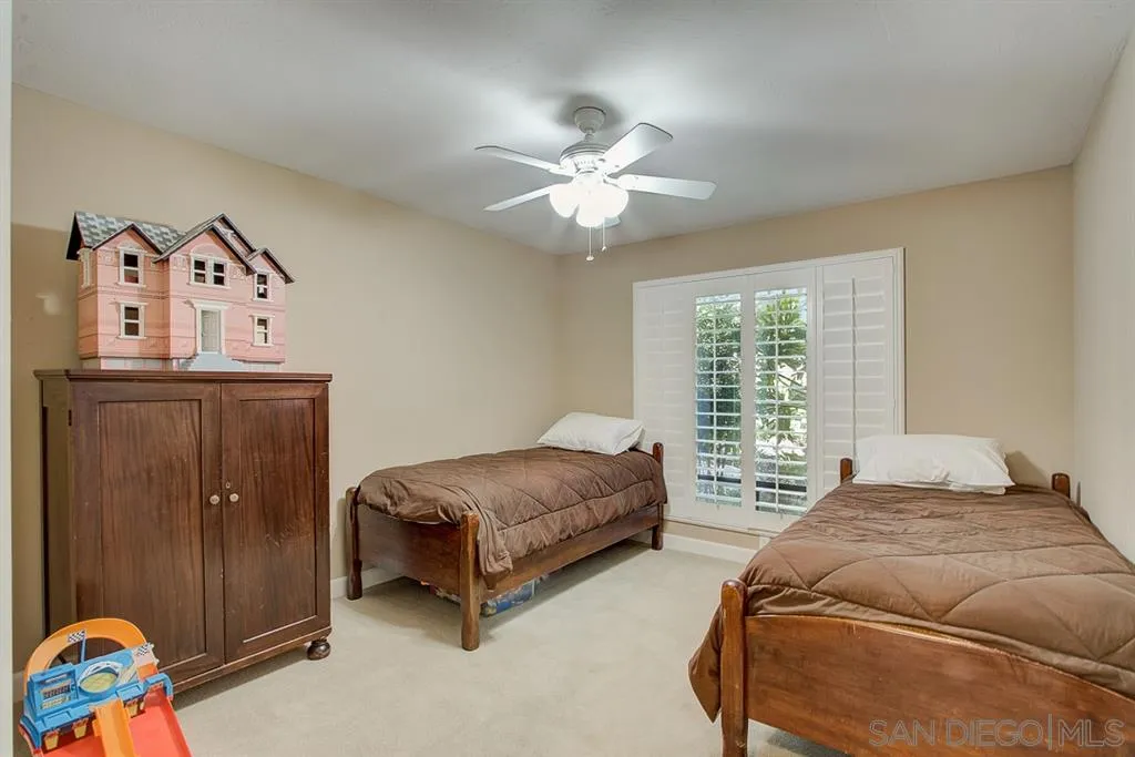 16508 Wilderness Road Poway, CA 92064 - Photo 12 of 25 a bedroom with a bed and a chandelier