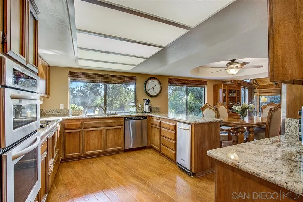 16508 Wilderness Road Poway, CA 92064 - Photo 6 of 25 a kitchen with stainless steel appliances granite countertop sink stove and refrigerator