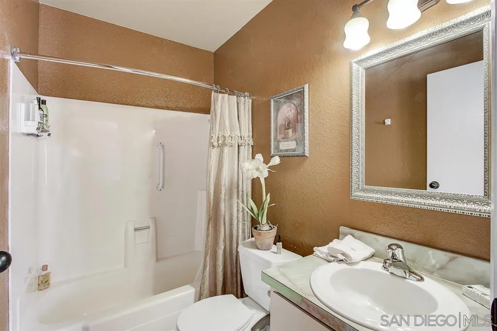 16508 Wilderness Road Poway, CA 92064 - Photo 10 of 25 a bathroom with a sink toilet and shower