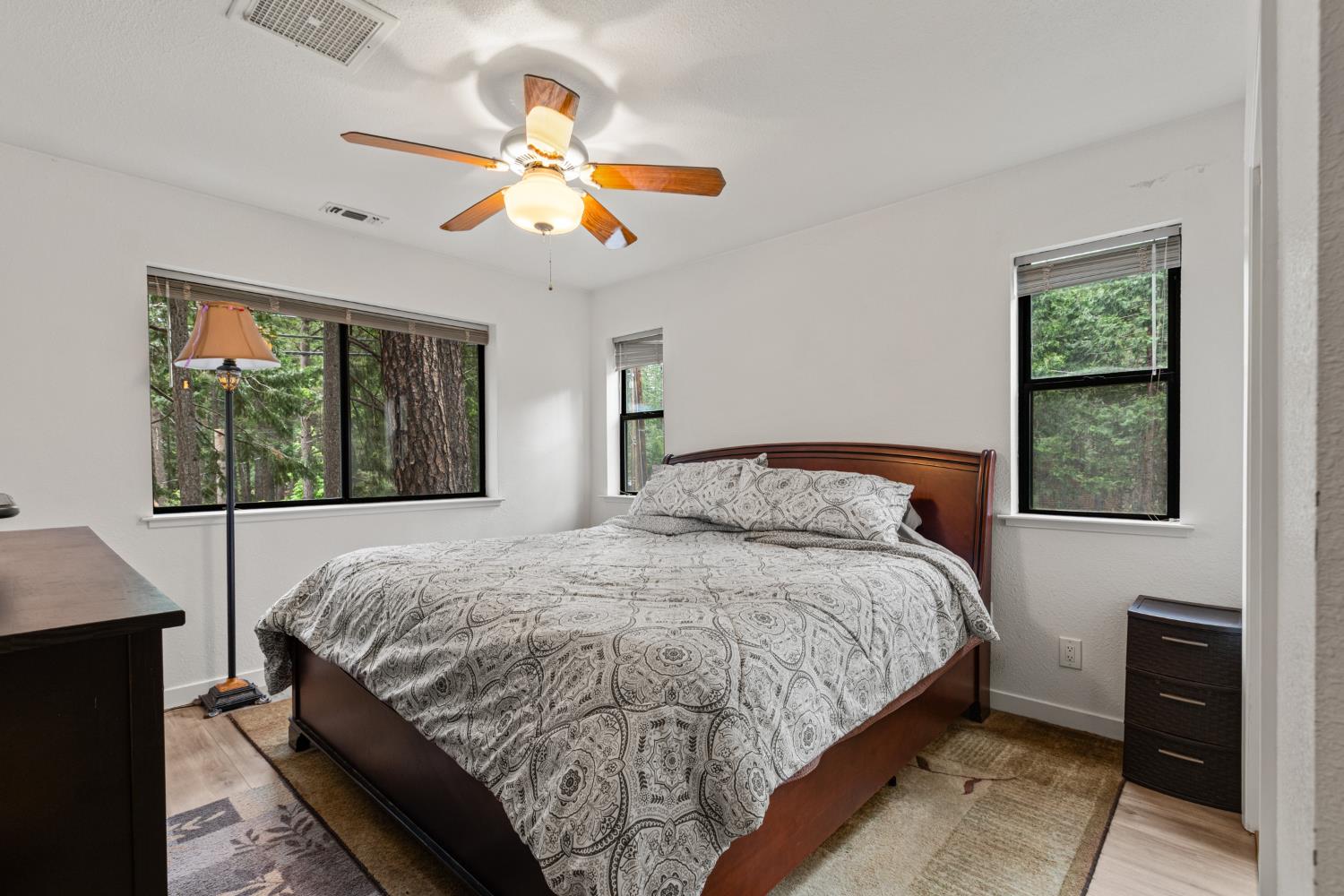 5680 Azalea Circle Pollock Pines, CA 95726 - Photo 16 of 31 a bedroom with a bed and a chandelier