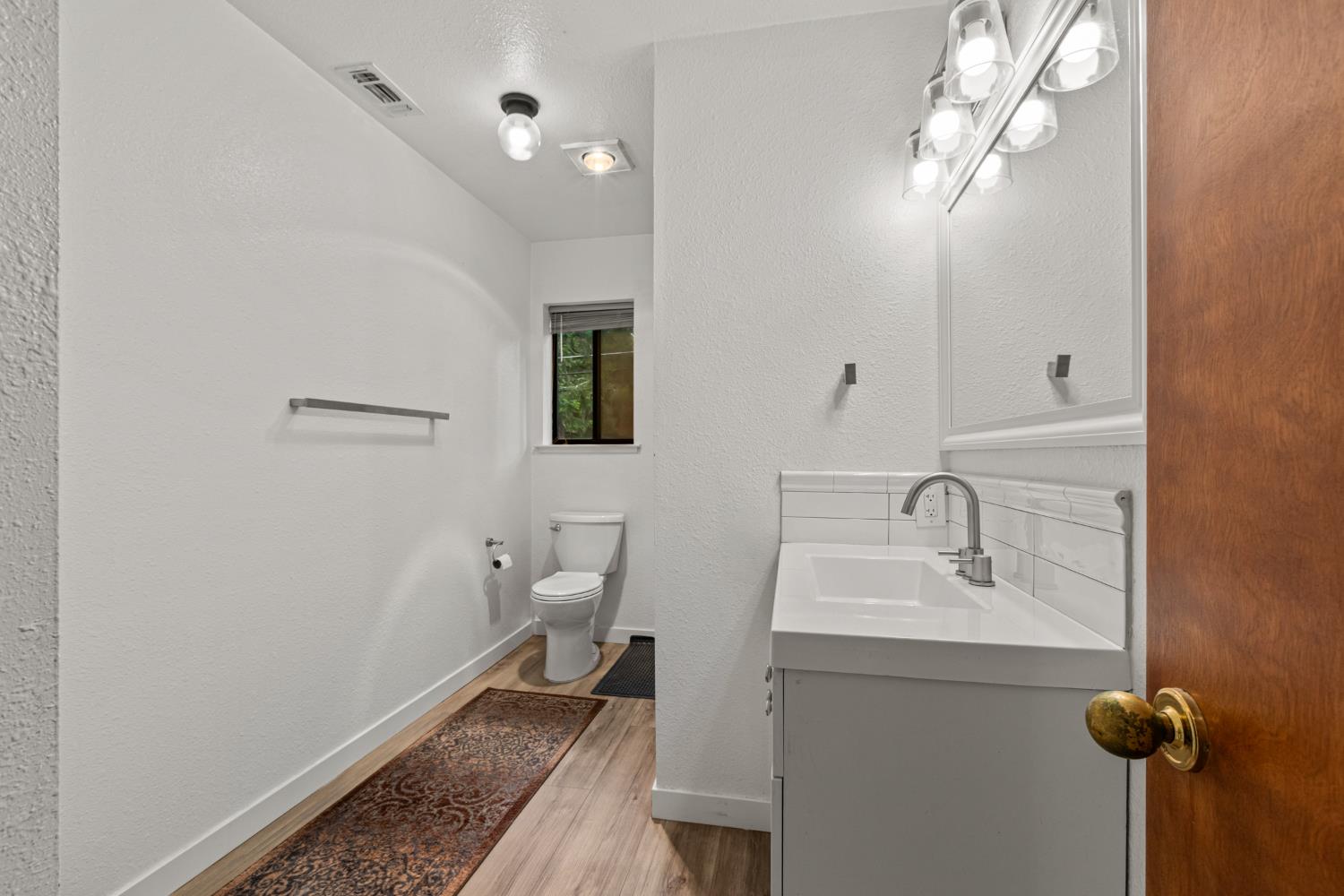 5680 Azalea Circle Pollock Pines, CA 95726 - Photo 18 of 31 a bathroom with a sink toilet and mirror