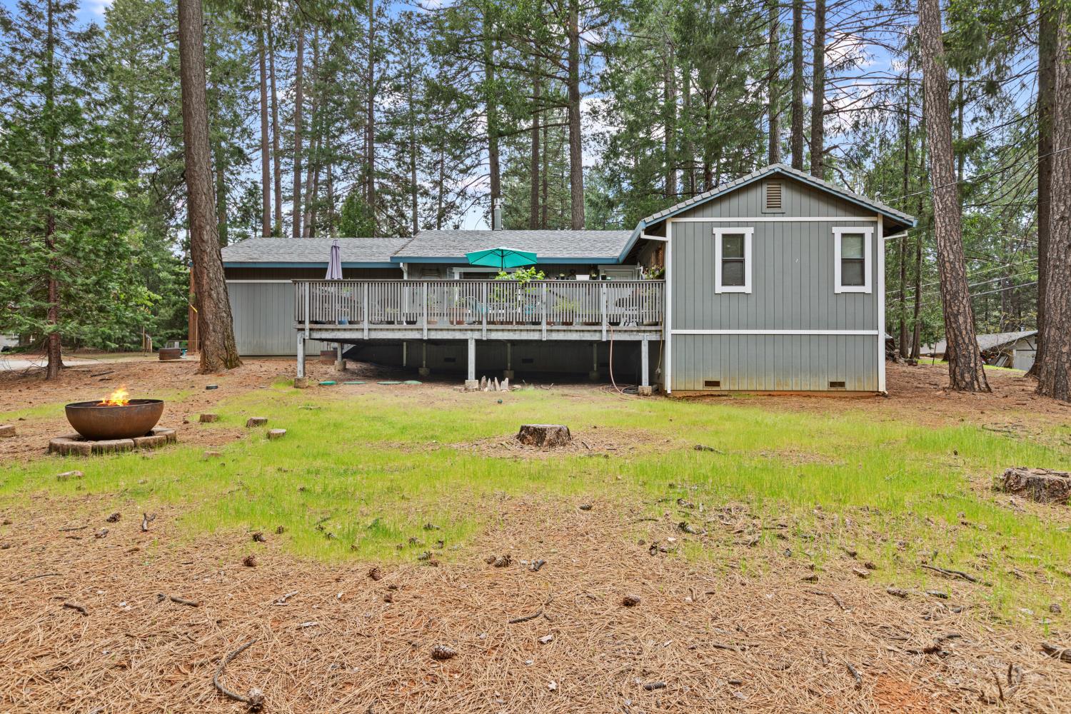 5680 Azalea Circle Pollock Pines, CA 95726 - Photo 2 of 31 a view of a house with backyard and trees