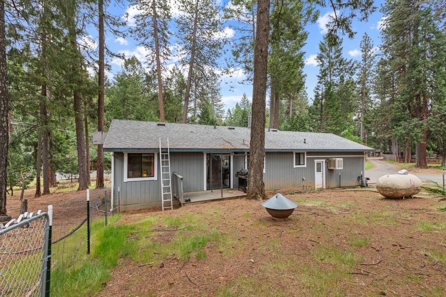 5680 Azalea Circle Pollock Pines, CA 95726 - Photo 29 of 31 a front view of a house with a garden and trees