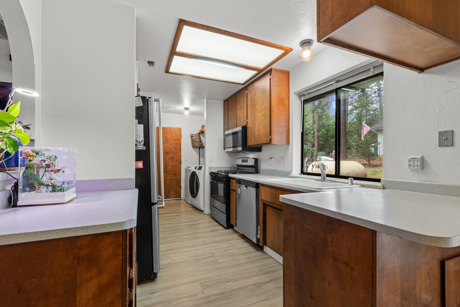 5680 Azalea Circle Pollock Pines, CA 95726 - Photo 3 of 31 a kitchen with granite countertop a sink appliances cabinets and dining table