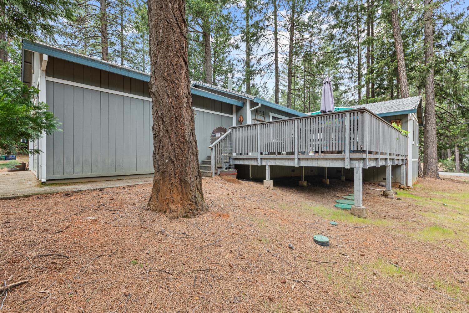 5680 Azalea Circle Pollock Pines, CA 95726 - Photo 31 of 31 a backyard of a house with wooden fence and deck