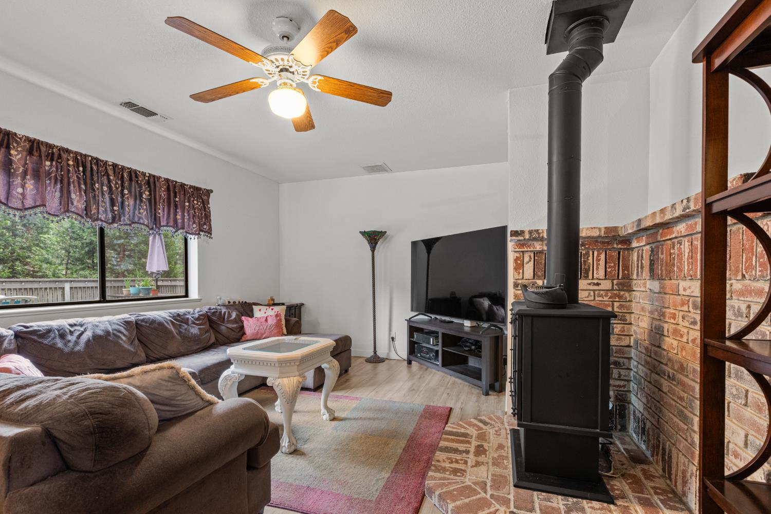 5680 Azalea Circle Pollock Pines, CA 95726 - Photo 5 of 31 a living room with furniture a ceiling fan and a window