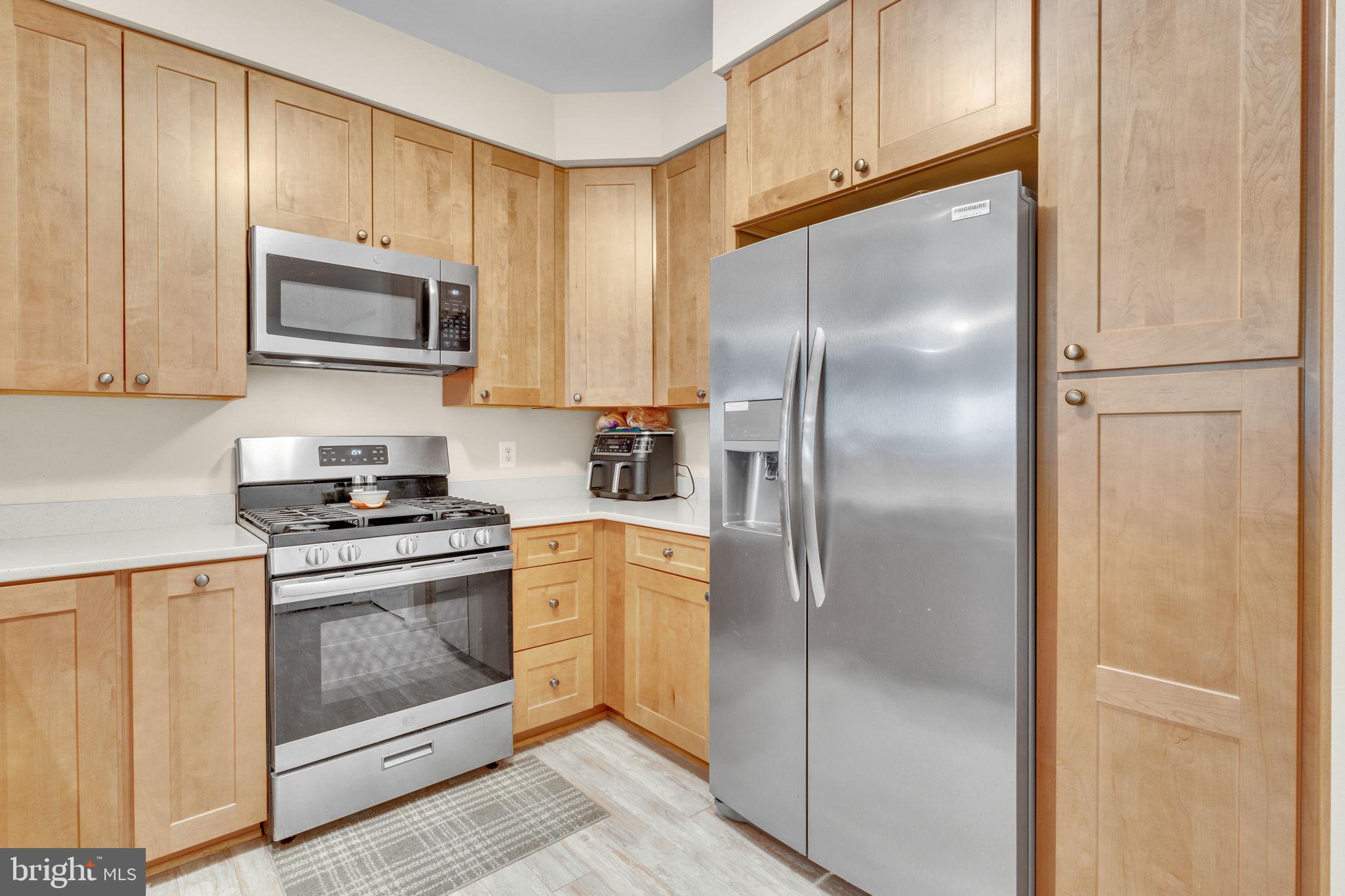 7706 Haynes Point Way, Unit 8F Alexandria, VA 22315 - Photo 10 of 36 a kitchen with stainless steel appliances granite countertop a refrigerator and a stove top oven