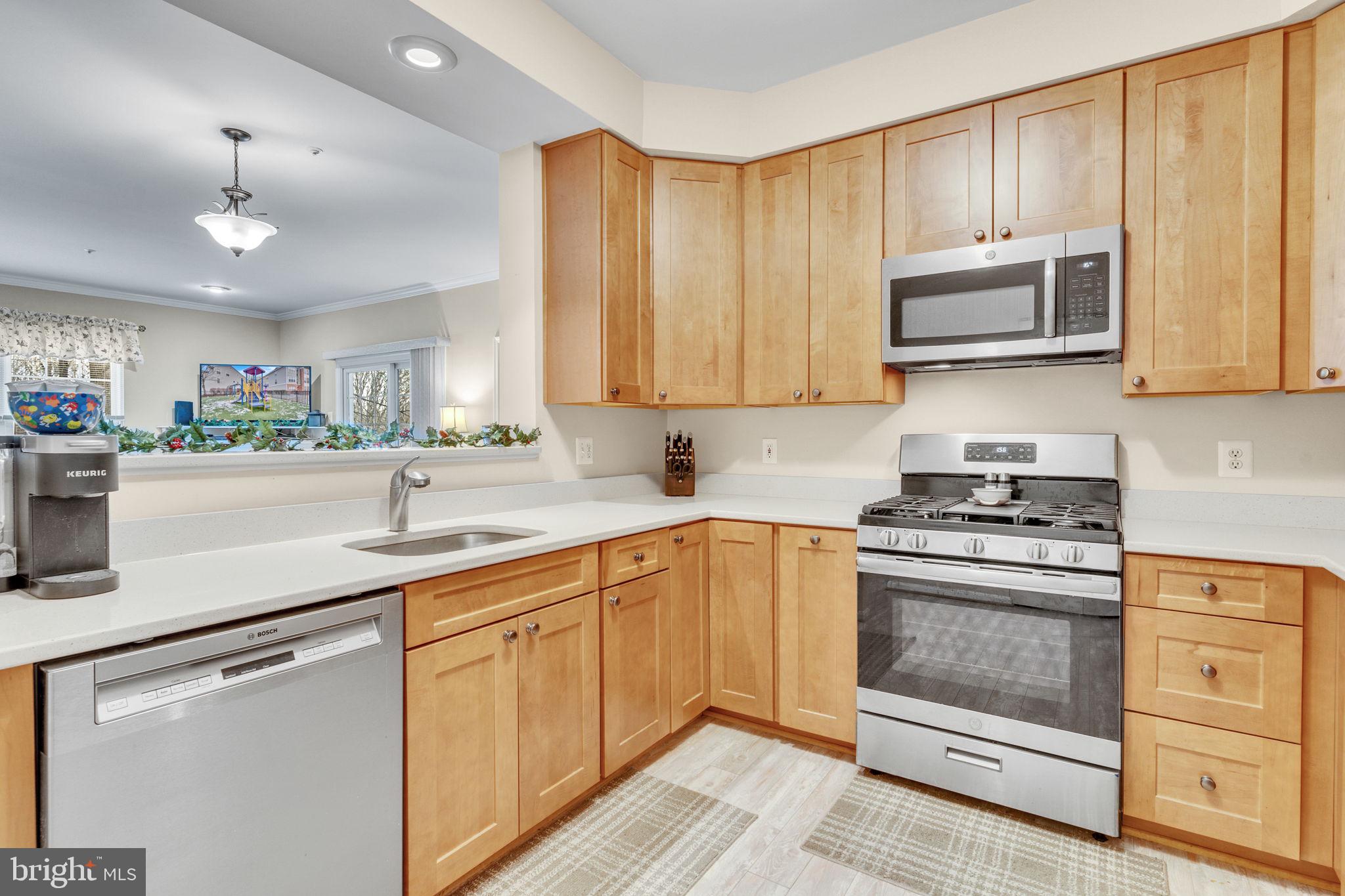 7706 Haynes Point Way, Unit 8F Alexandria, VA 22315 - Photo 11 of 36 a kitchen with stainless steel appliances granite countertop a sink and a stove