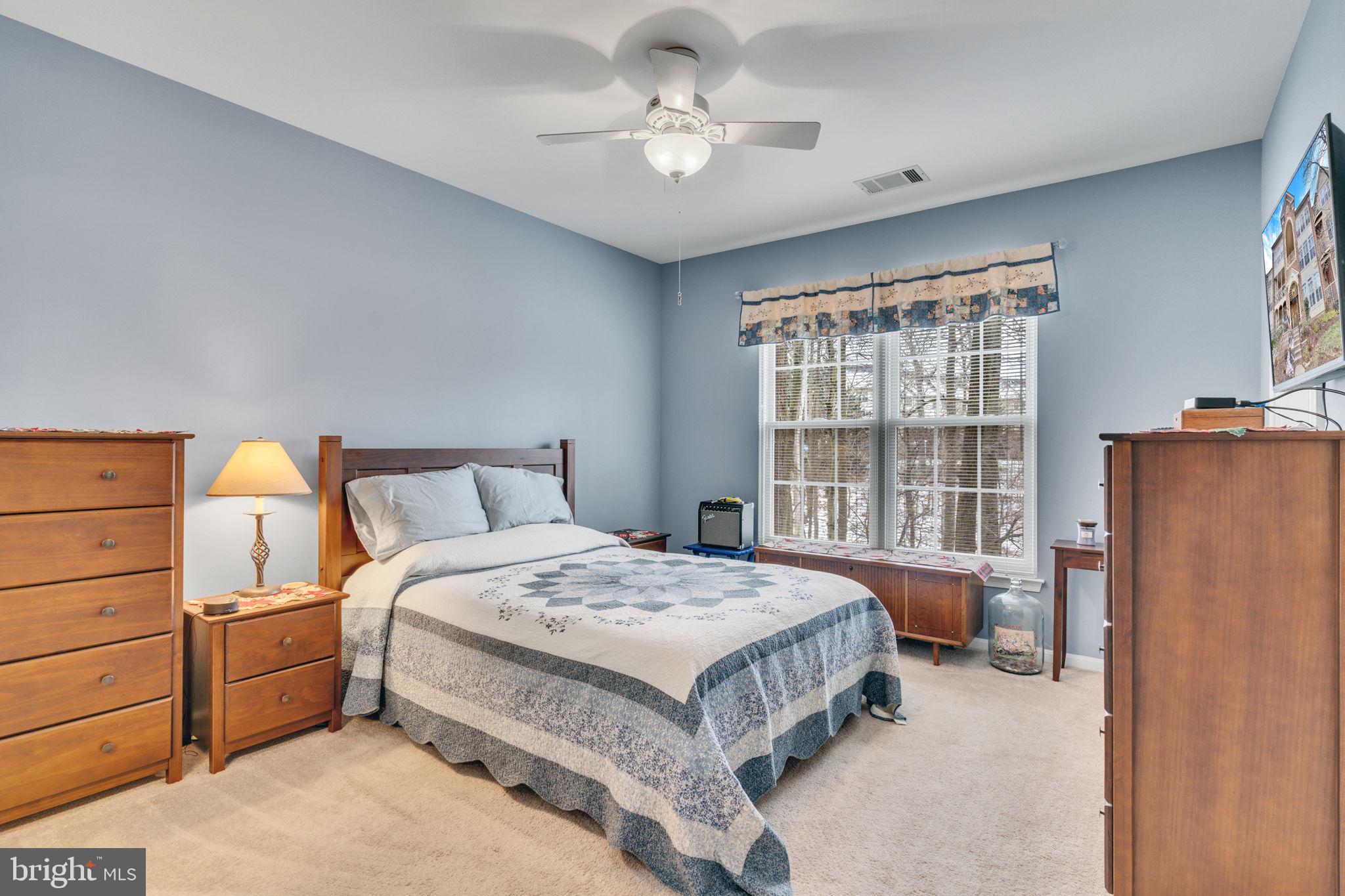7706 Haynes Point Way, Unit 8F Alexandria, VA 22315 - Photo 16 of 36 a bedroom with a bed dresser and a window