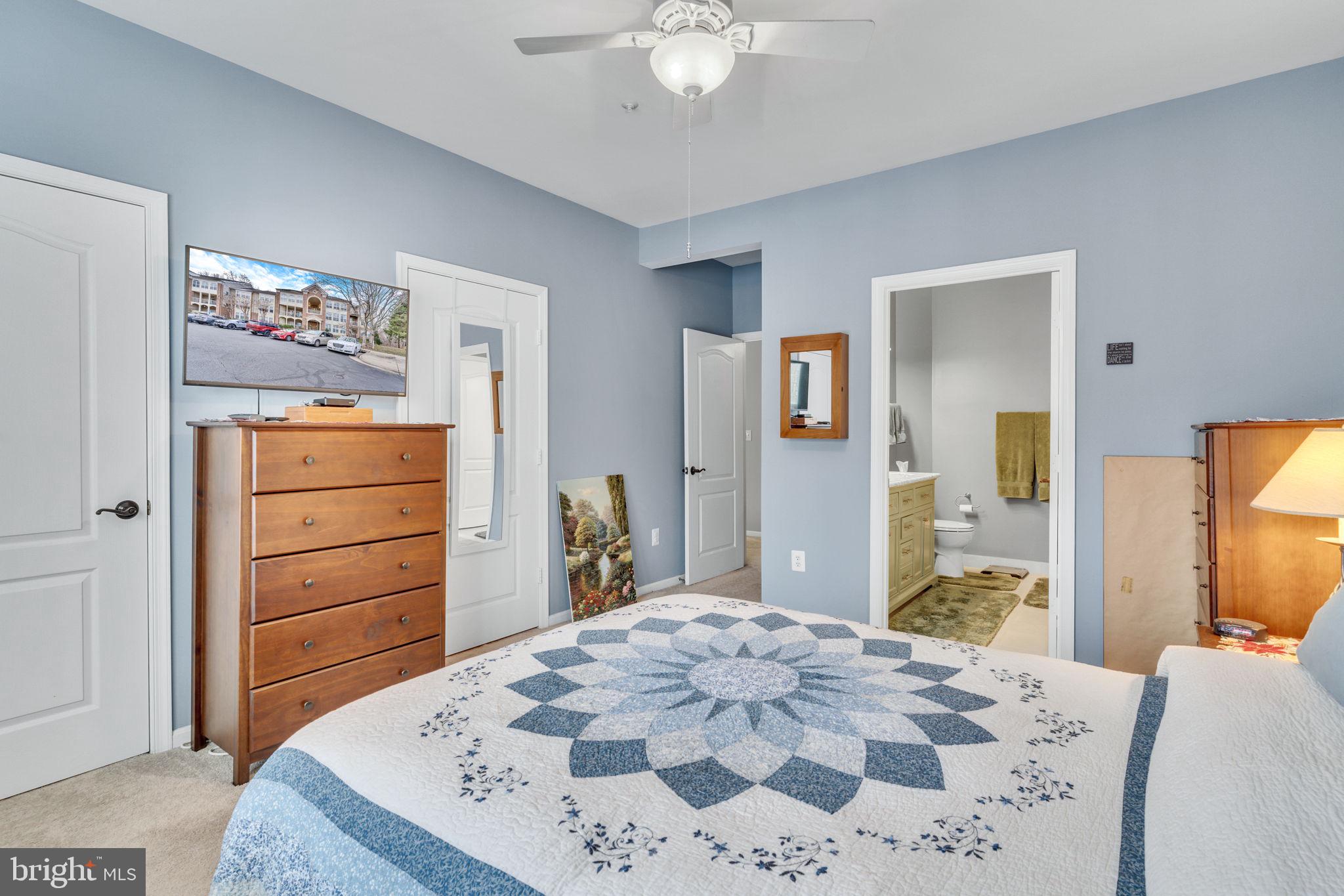 7706 Haynes Point Way, Unit 8F Alexandria, VA 22315 - Photo 17 of 36 a bedroom with a bed and a mirror on dresser