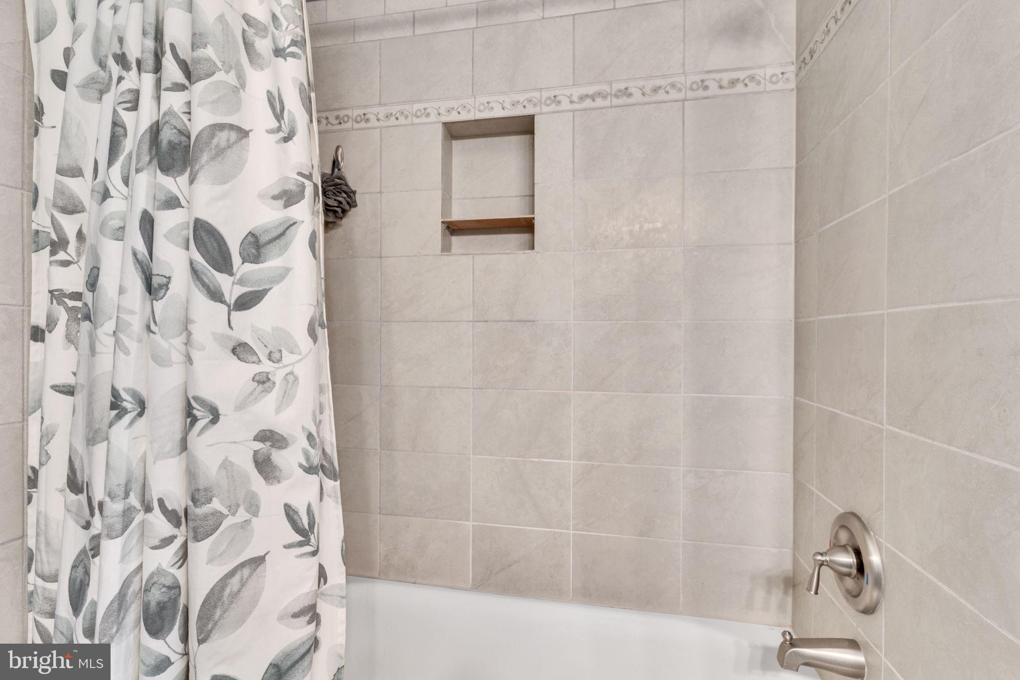 7706 Haynes Point Way, Unit 8F Alexandria, VA 22315 - Photo 20 of 36 a bathroom with a shower curtain