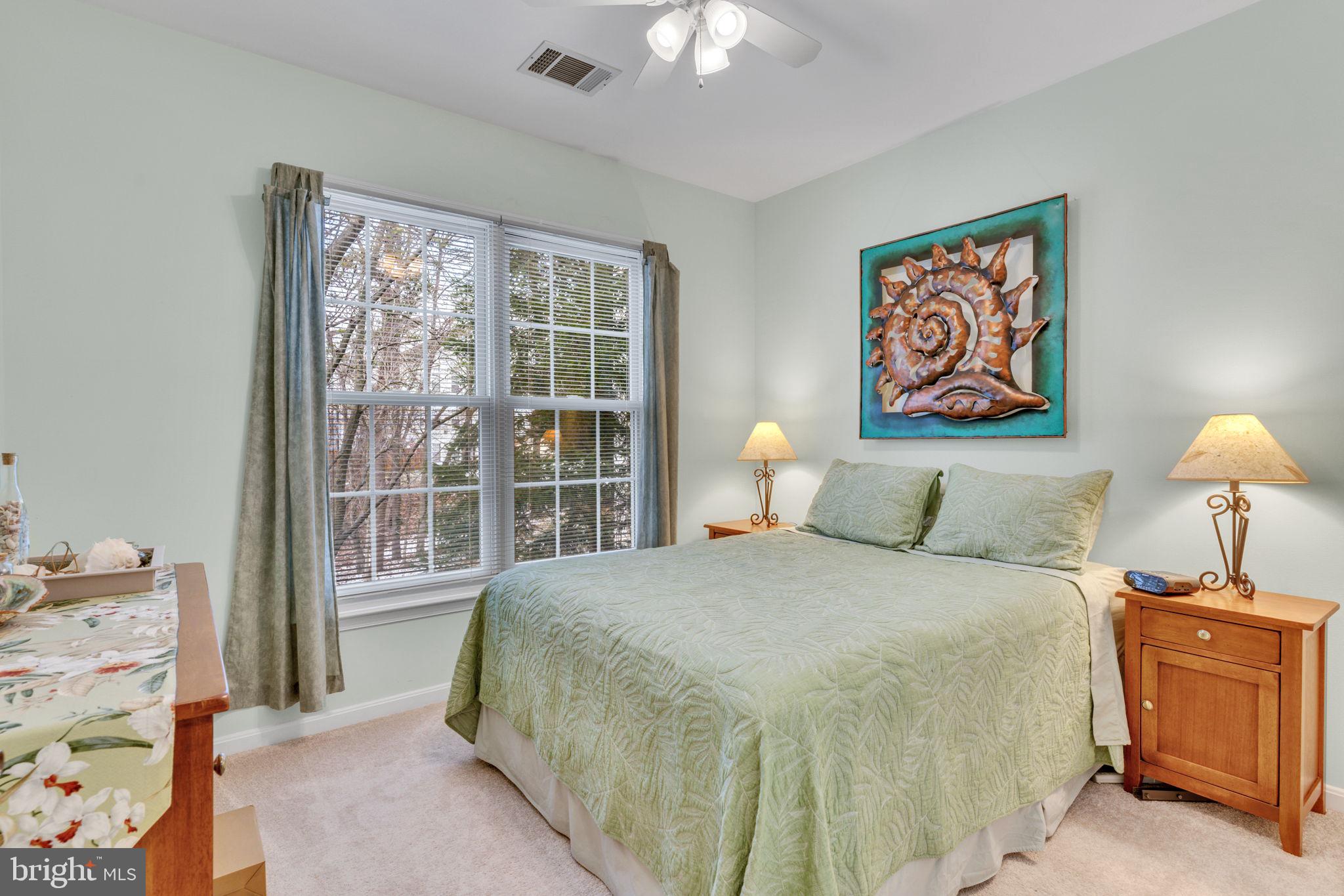 7706 Haynes Point Way, Unit 8F Alexandria, VA 22315 - Photo 22 of 36 a bedroom with a bed and a lamp on dresser