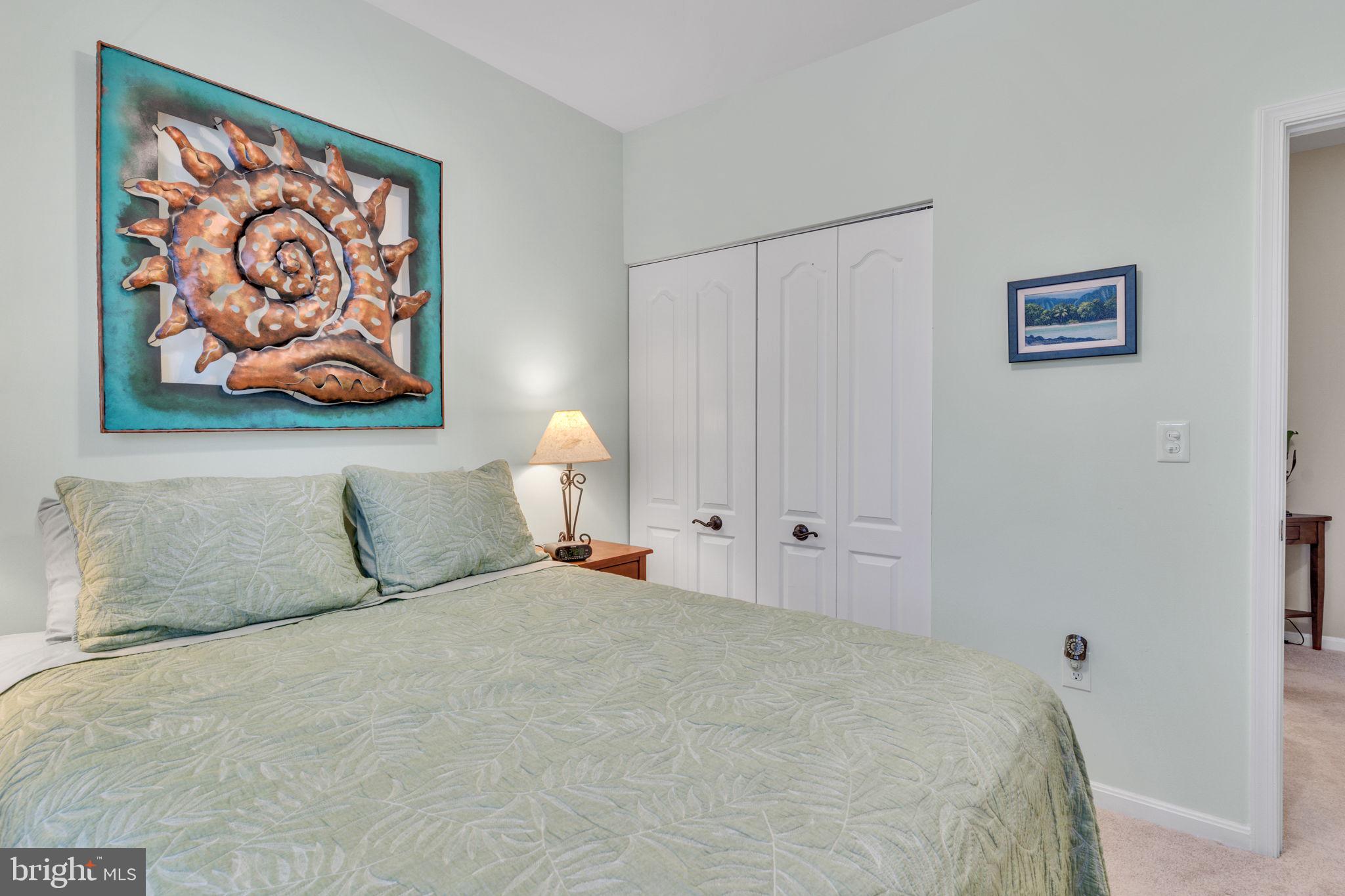7706 Haynes Point Way, Unit 8F Alexandria, VA 22315 - Photo 23 of 36 a bedroom with a bed and a painting on the wall