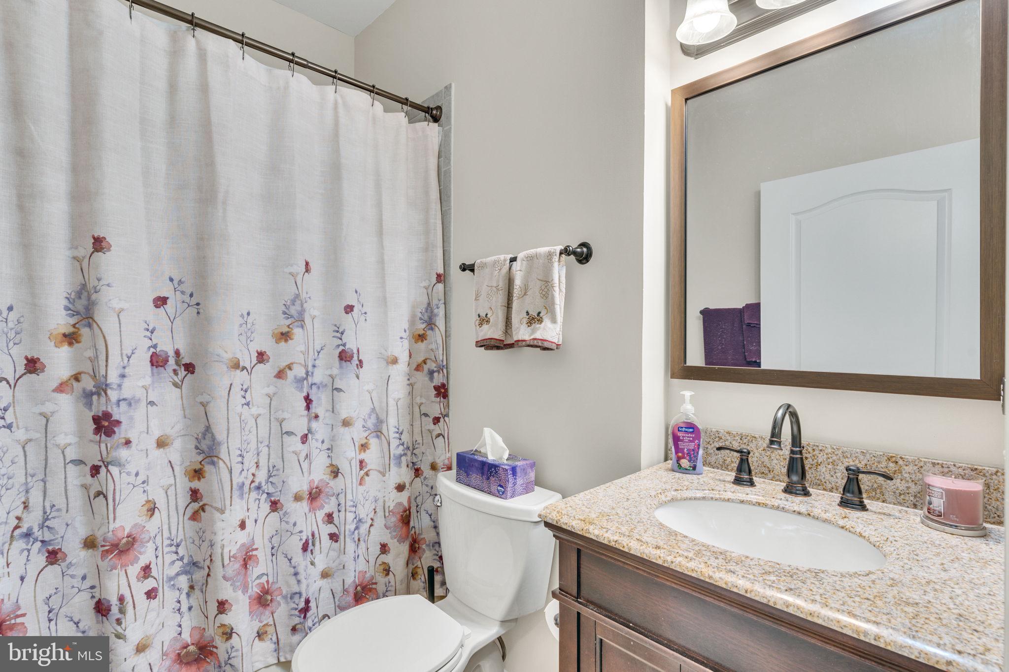 7706 Haynes Point Way, Unit 8F Alexandria, VA 22315 - Photo 27 of 36 a bathroom with a granite countertop sink mirror and toilet