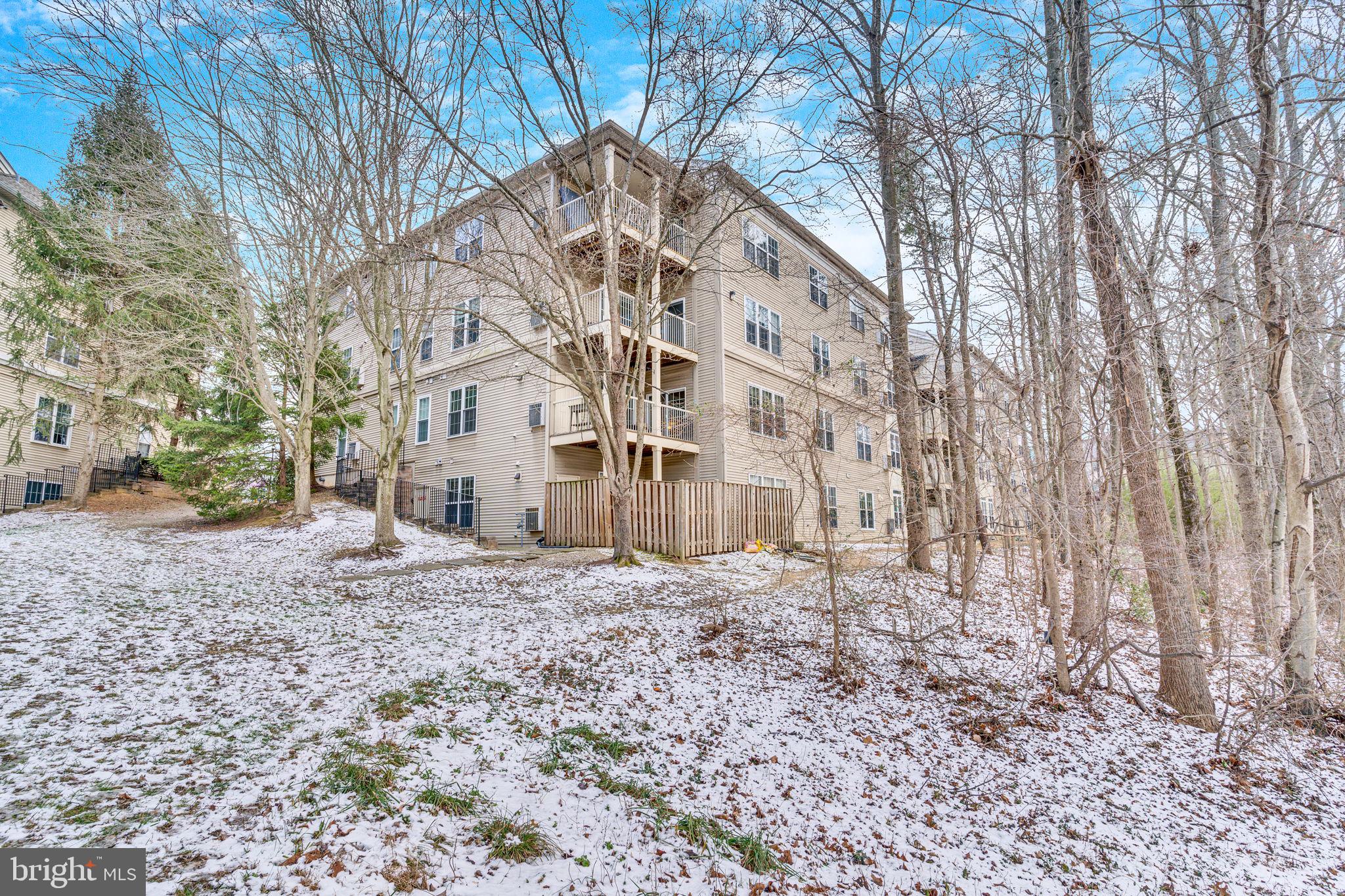 7706 Haynes Point Way, Unit 8F Alexandria, VA 22315 - Photo 33 of 36 a view of a big building with large trees