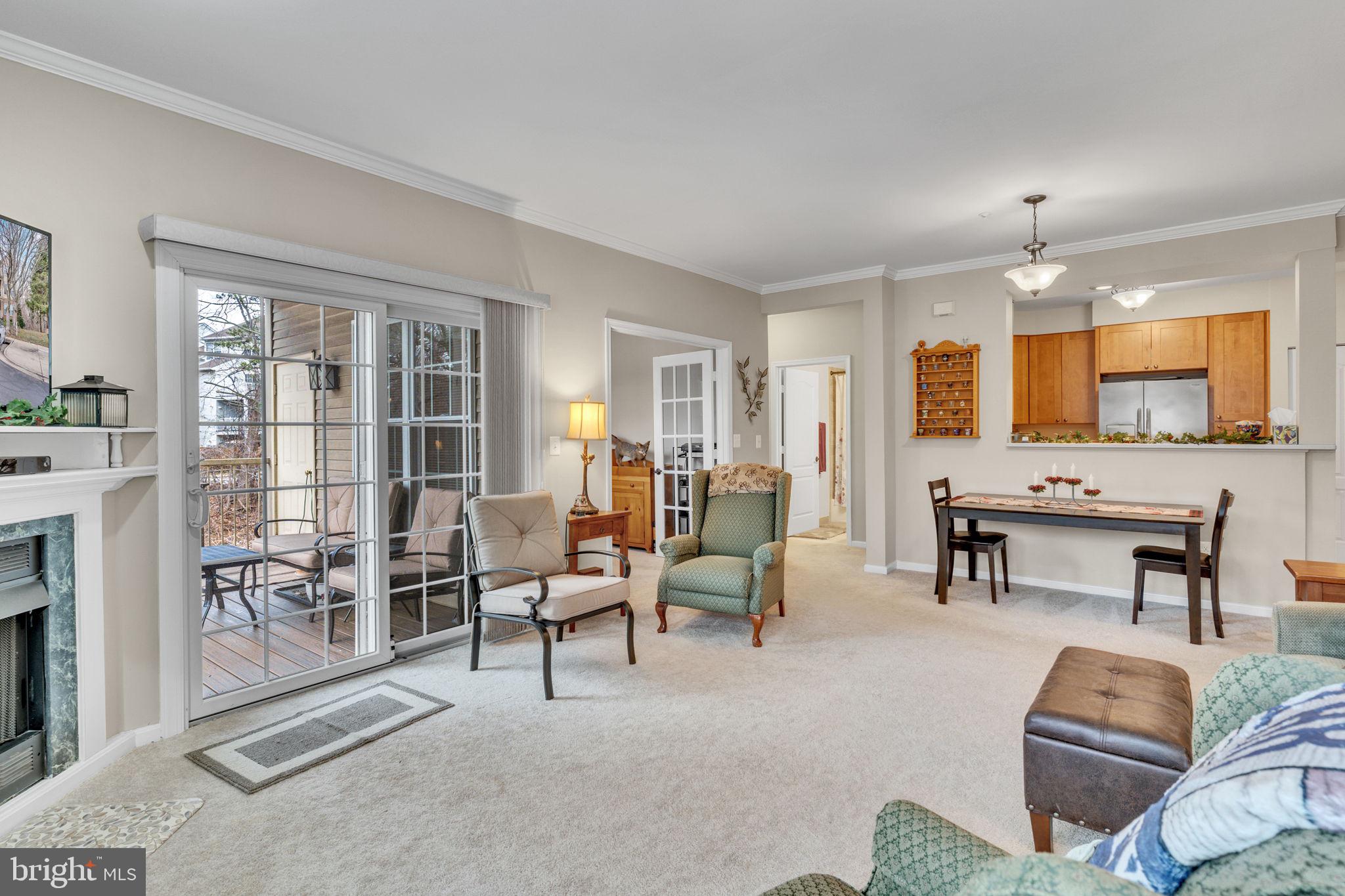 7706 Haynes Point Way, Unit 8F Alexandria, VA 22315 - Photo 6 of 36 a living room with furniture and a large window