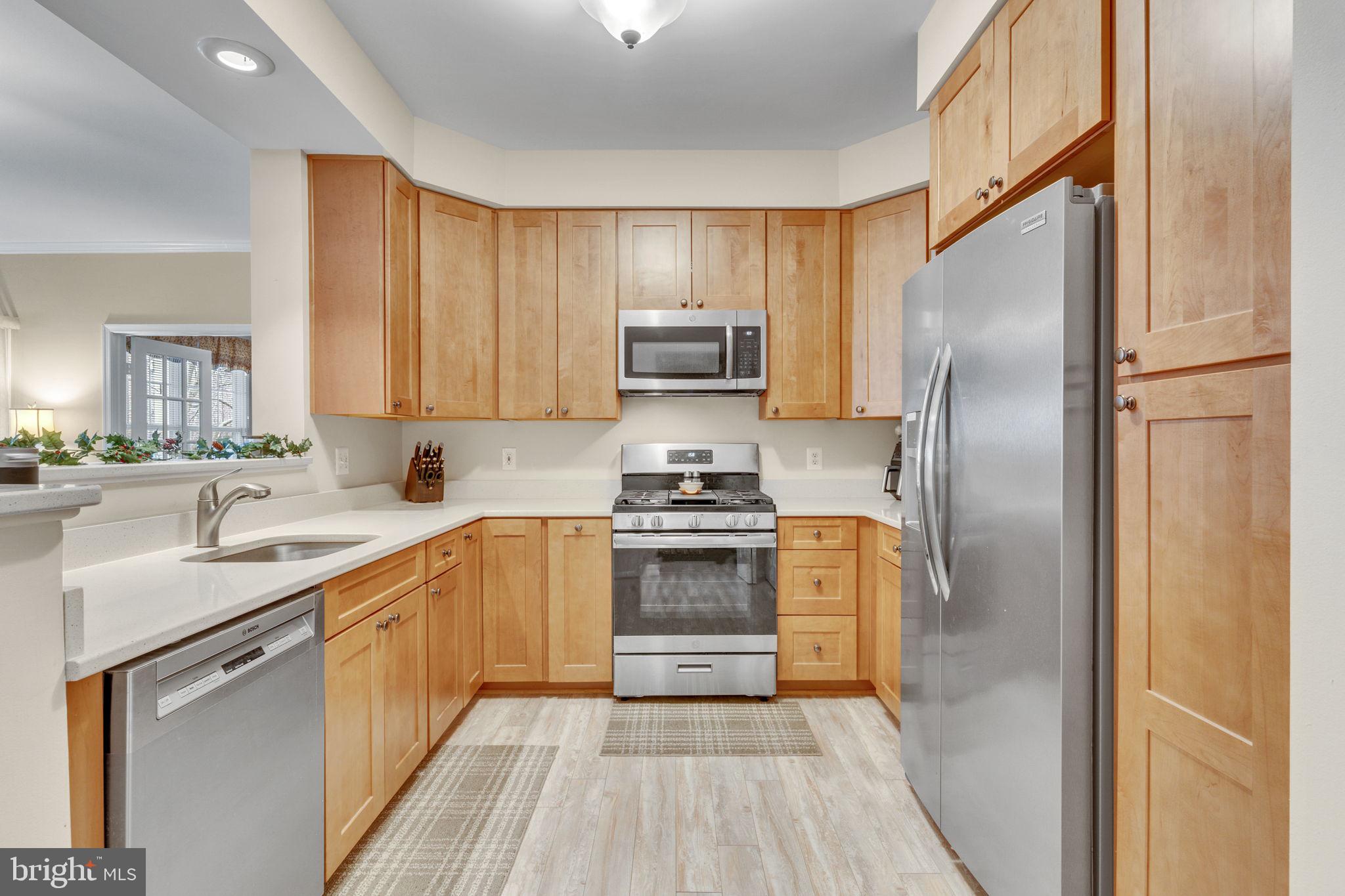7706 Haynes Point Way, Unit 8F Alexandria, VA 22315 - Photo 9 of 36 a kitchen with a refrigerator sink and cabinets