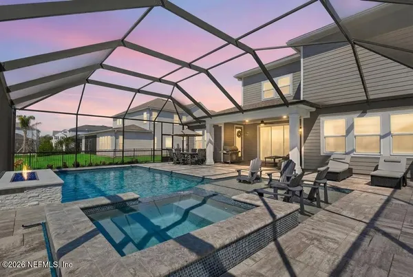 a view of swimming pool with outdoor seating and plants