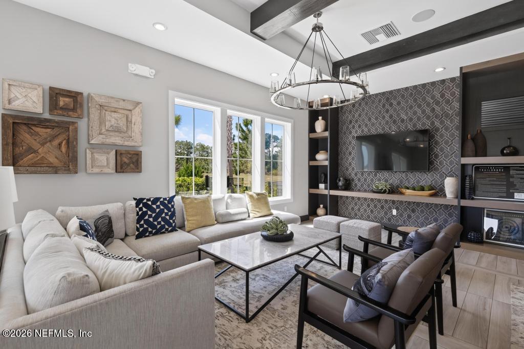 240 Ranch Land Circle St. Johns, FL 32259 - Photo 111 of 117 a living room with furniture a chandelier and a flat screen tv