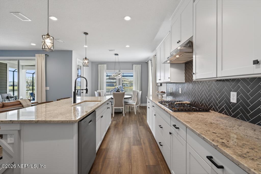 240 Ranch Land Circle St. Johns, FL 32259 - Photo 11 of 117 a large kitchen with granite countertop a large counter top a sink stainless steel appliances and cabinets